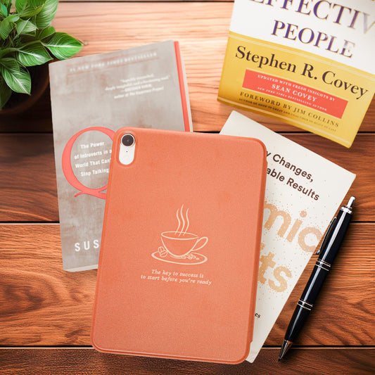 coffee-inspired iPad Mini case with a coffee cup design on a wooden surface with books and a pen.